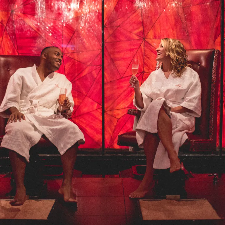 Couple in white robes sitting in salt room at Reflections Spa