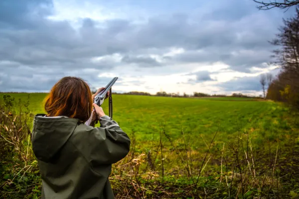 Woman pointing laser gun towards the sky.