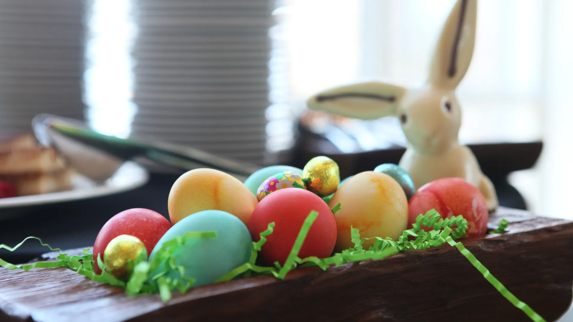 Dyed eggs in wooden basket.