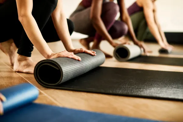 Rolling up yoga mats.